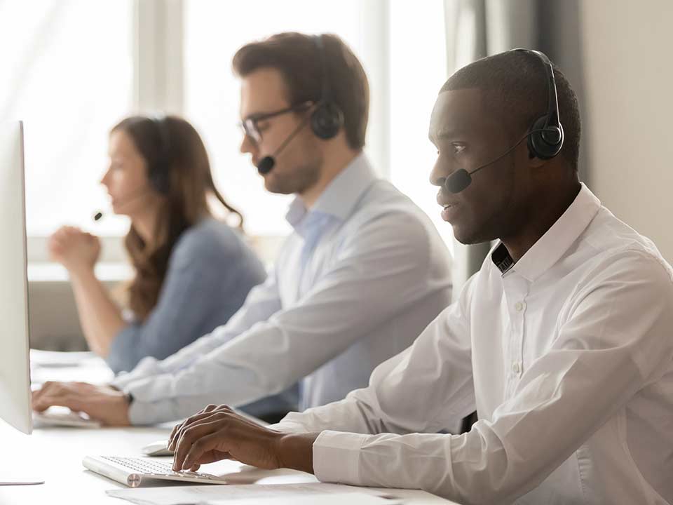 people working at computers and monitoring security systems