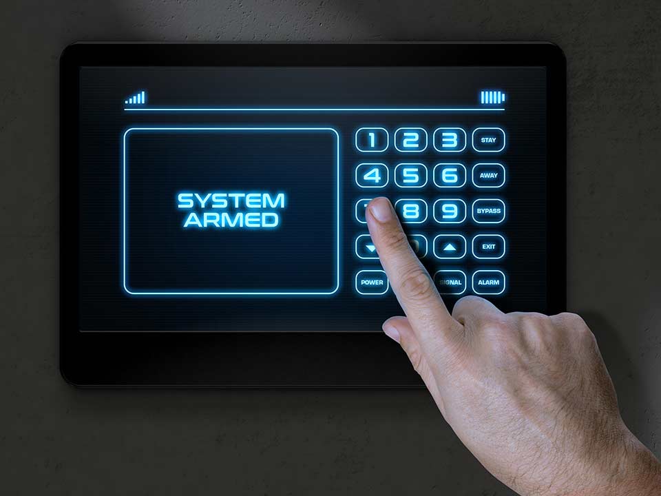 person entering numbers on a security system key pad